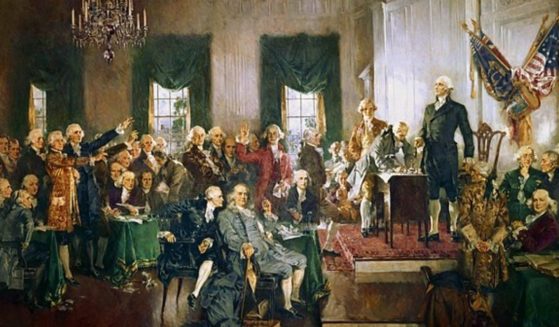 The Founding Fathers sign the Constitution.