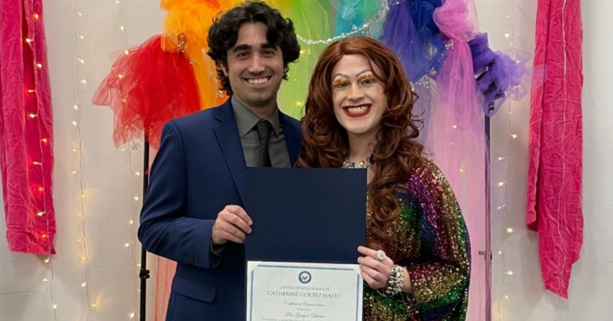 The Nevada Democrat sent an aide to present an award to the drag queen, who uses the name "Miss Ginger Devine."