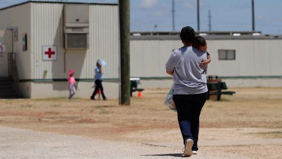 A mother and son seeking asylum walk at the Ice South Texas Family Residential Center in Dilley, Texas, on Aug. 23, 2019.