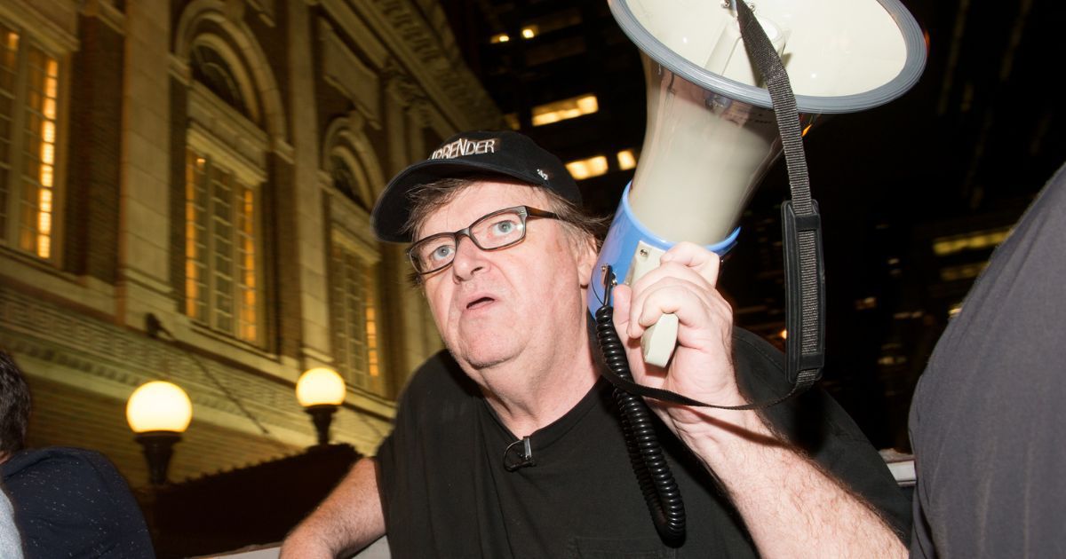 Filmmaker Michael Moore protests outside of Trump Tower in New York City on Aug. 15, 2017.