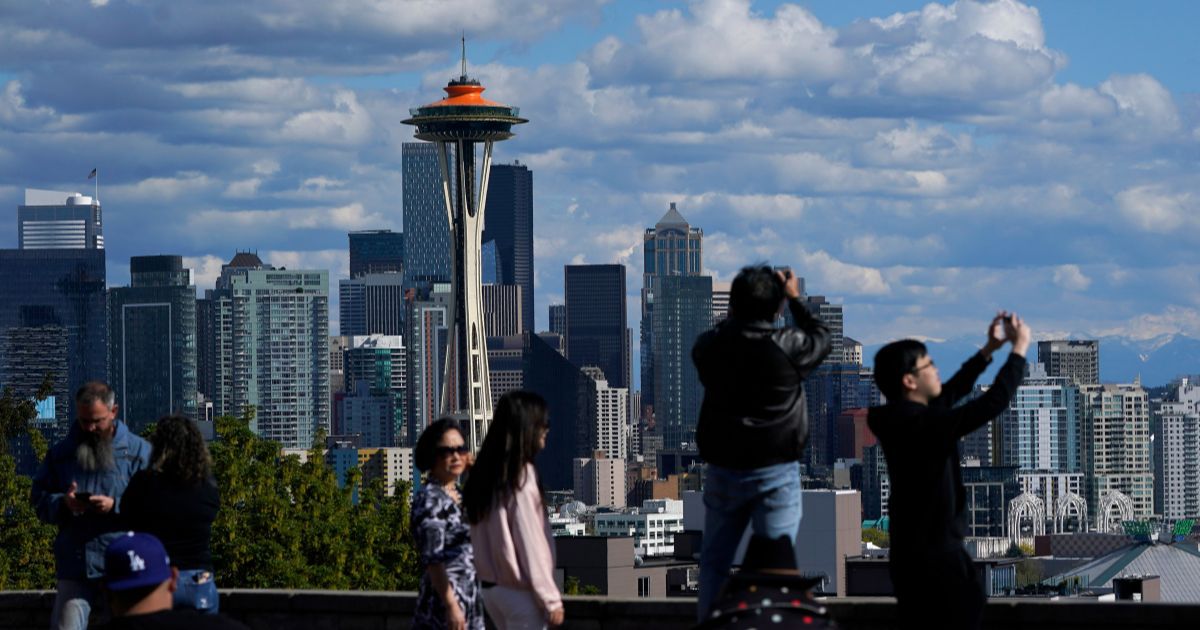 Visitors are pictured at Kerry Park, in front of the Seattle Space Needle in Washington on May 10.