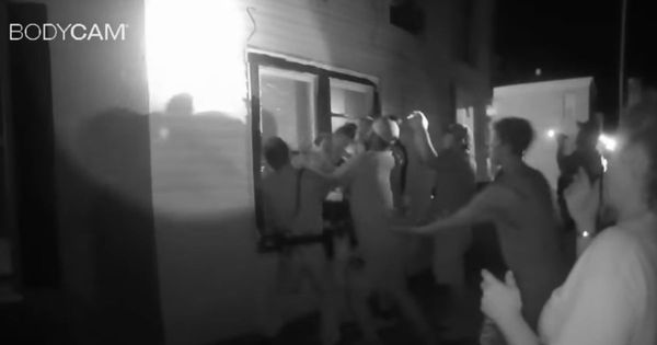 Body-cam footage from a Madison, Indiana, police officer shows the group of officers that gathered beneath a burning apartment's window to catch leaping survivors on July 3.