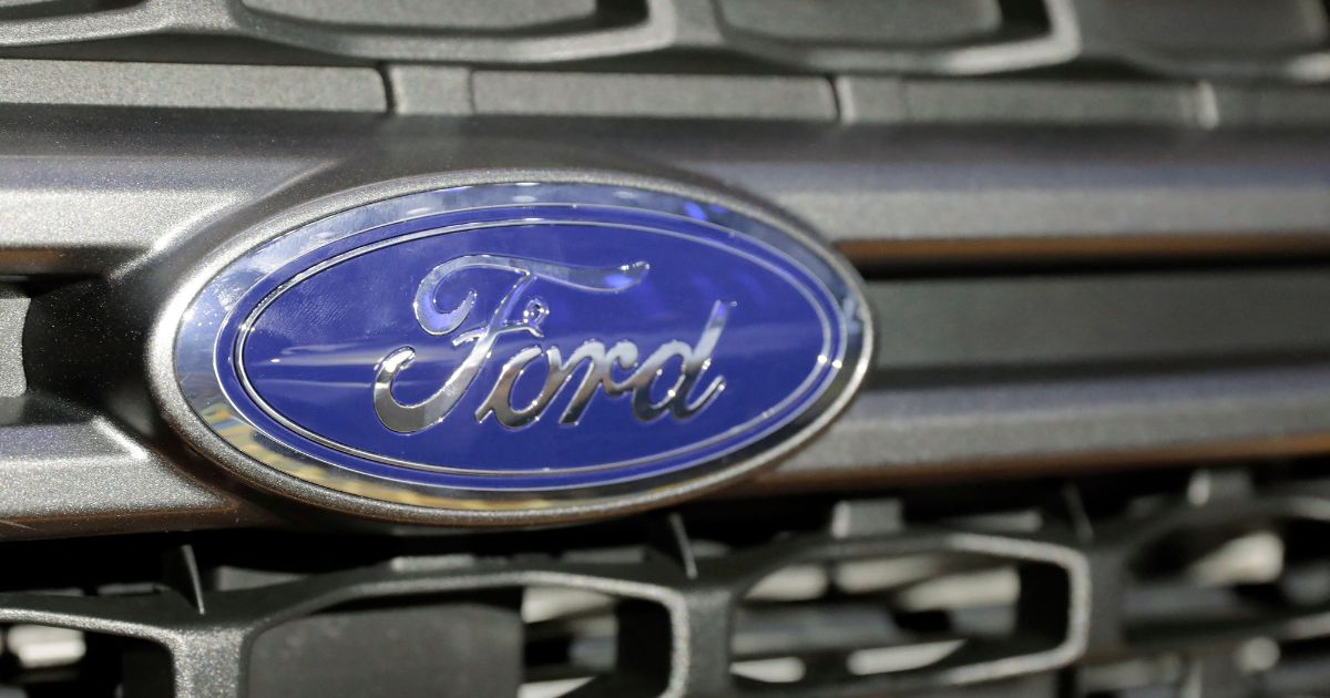 The Ford logo is seen on the grill of a Maverick Hybrid pickup at Huntington Place in Detroit on Jan. 11.