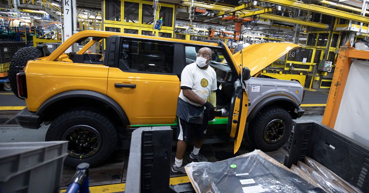 A man works on the Ford Bronco assembly line at the Ford Michigan Assembly Plant in Wayne on June 14, 2021.
