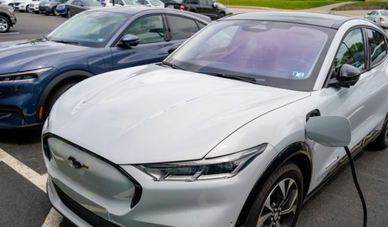 Two 2021 Ford Mustang Mach-Es charge at a Ford dealer in Wexford, Pennsylvania, on May 6, 2021.