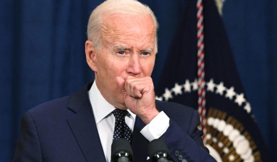 A July 15 photo shows President Joe Biden coughing as he speaks to the traveling press after taking part in a working session with Saudi Arabia's Crown Prince Mohammed bin Salman last week in Jeddah, Saudi Arabia.