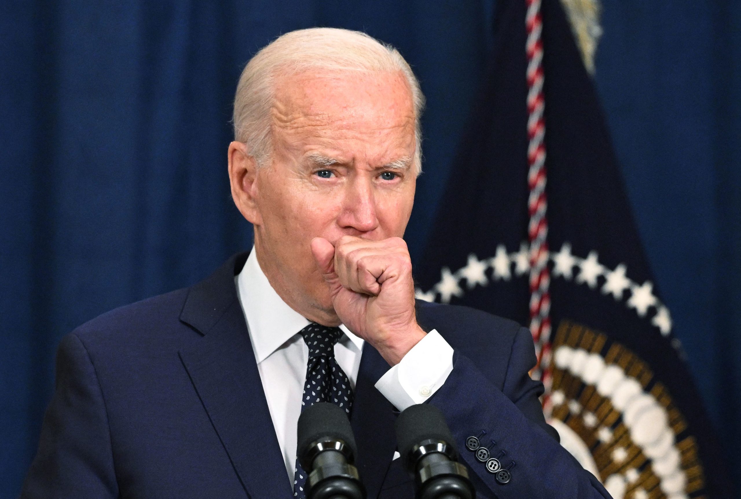 A July 15 photo shows President Joe Biden coughing as he speaks to the traveling press after taking part in a working session with Saudi Arabia's Crown Prince Mohammed bin Salman last week in Jeddah, Saudi Arabia.