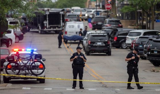 First responders remove victims from the scene of a mass shooting at a Fourth of July parade in Highland Park, Illinois, on Monday.