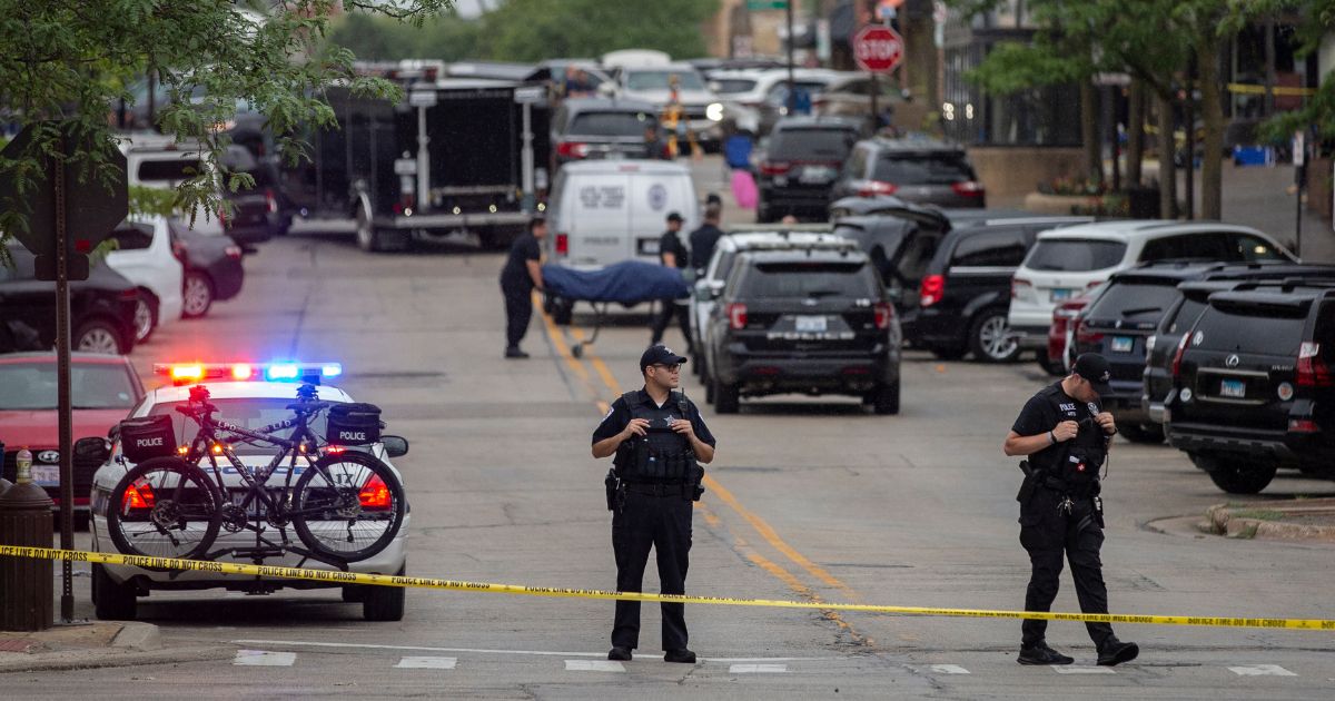 First responders remove victims from the scene of a mass shooting at a Fourth of July parade in Highland Park, Illinois, on Monday.