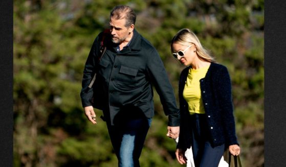 Hunter Biden, left, and his wife Melissa Cohen walk to a vehicle after disembarking Marine One in Washington, April 17, following a weekend at Camp David.