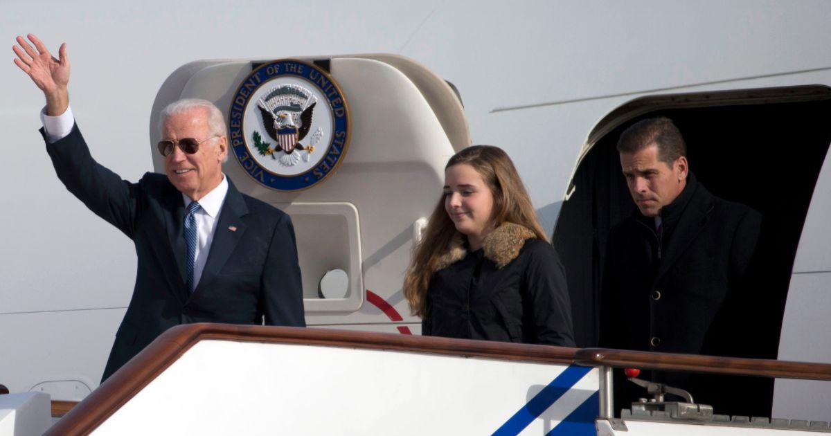 Then-Vice President Joe Biden, left, waves as he walks out of Air Force Two with his granddaughter, Finnegan Biden, middle, and son Hunter Biden, right, upon their arrival in Beijing on Dec. 4, 2013.