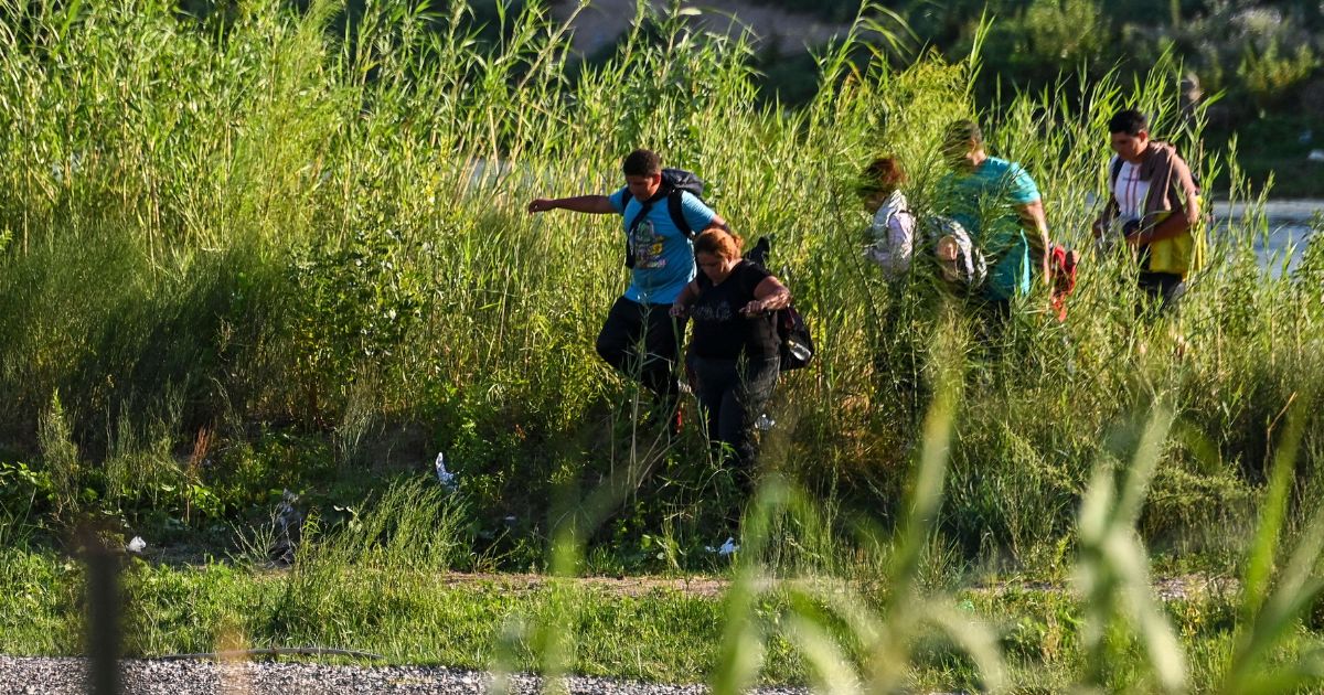 A migrant family illegally enters the United States by crossing the Rio Grande River near Eagle Pass, Texas, on June 30.