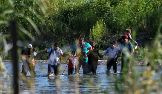 Illegal immigrants from Venezuela cross the Rio Grande from Mexico into Eagle Pass, Texas, on Thursday.