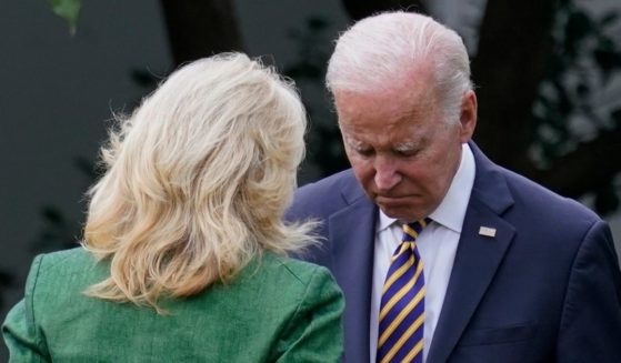 President Joe Biden speaks with first lady Jill Biden before boarding Marine One in Washington on Wednesday.