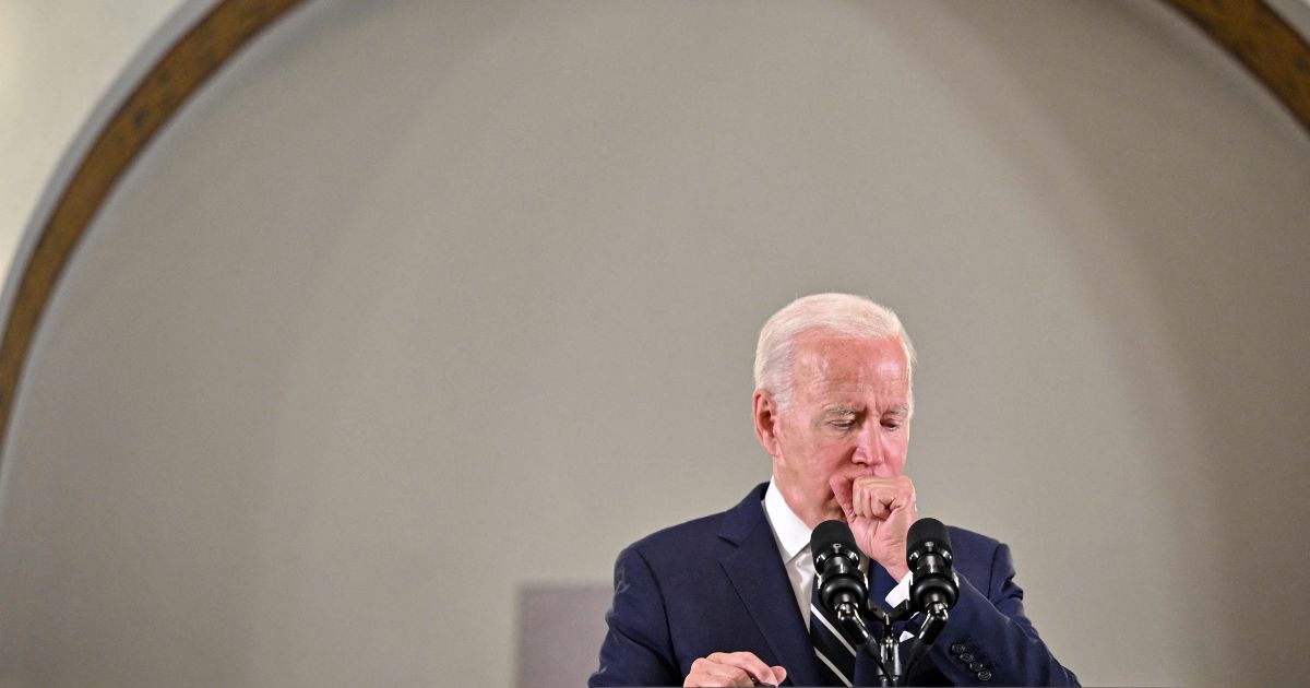 President Joe Biden coughs as he delivers remarks during a visit to the Augusta Victoria Hospital in Jerusalem on Friday.