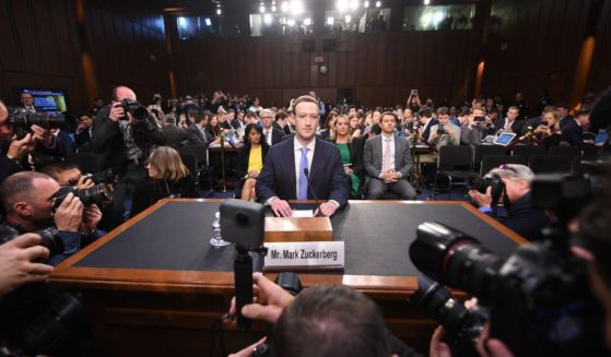 Facebook CEO Mark Zuckerberg is surrounded by cameras as he prepares to testify before a joint Senate hearing in Washington, D.C., on April 10, 2018.