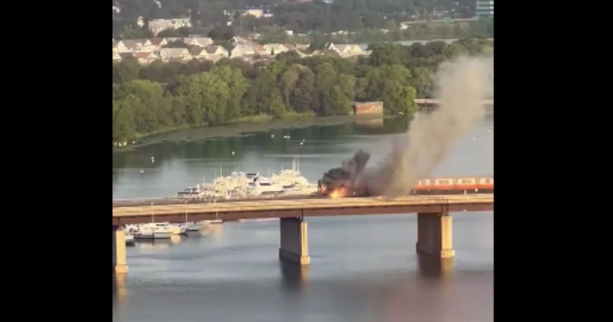 A train caught fire in Massachusetts on Thursday, forcing passengers to evacuate as it went over the river.