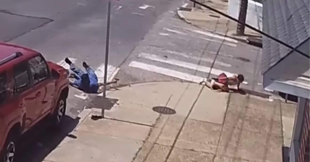 Two men level pistols at each other on a Philadelphia street corner