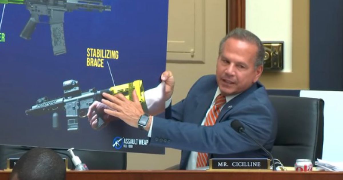 Rep. David Cicilline points to a diagram while claiming that a stabilizing brace can turn a gun into an automatic weapon.