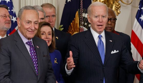 Senate Majority Leader Charles Schumer, left, stands with President Joe Biden and other Democrats during an event in the State Dining Room of the White House in Washington on April 6.