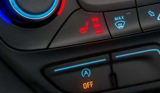 The seat heater button, a feature present in most modern vehicles, is turned up to its warmest setting.