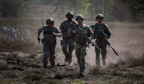 Snipers assigned to Army's 1st Battalion, 8th Infantry Regiment, 3rd Armored Brigade Combat Team, 4th Infantry Division, run to cover during a situational training exercise at Oberlausitz Training Area in Germany on May 16.