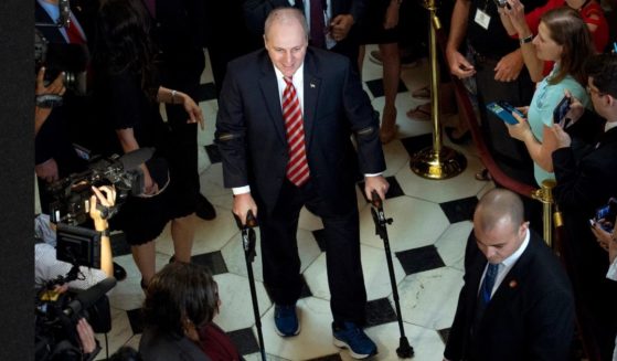 Then-House Republican Whip Steve Scalise is seen leaving the House chamber in the Capitol in Washington on Sept. 28, 2017, to hugs and a roaring bipartisan standing ovation. Scalise and four others were shot by a liberal activist five years ago during practice for a Congressional baseball game. The incident left Scalise fighting for his life, but he was able to return to Congress after three months' rehabilitation. Now, another liberal group is planning a protest at the annual Congressional baseball game.