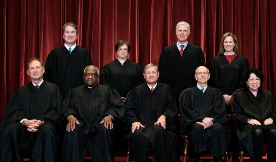 The members of the Supreme Court pose for a group photo in Washington, D.C., on April 23, 2021.