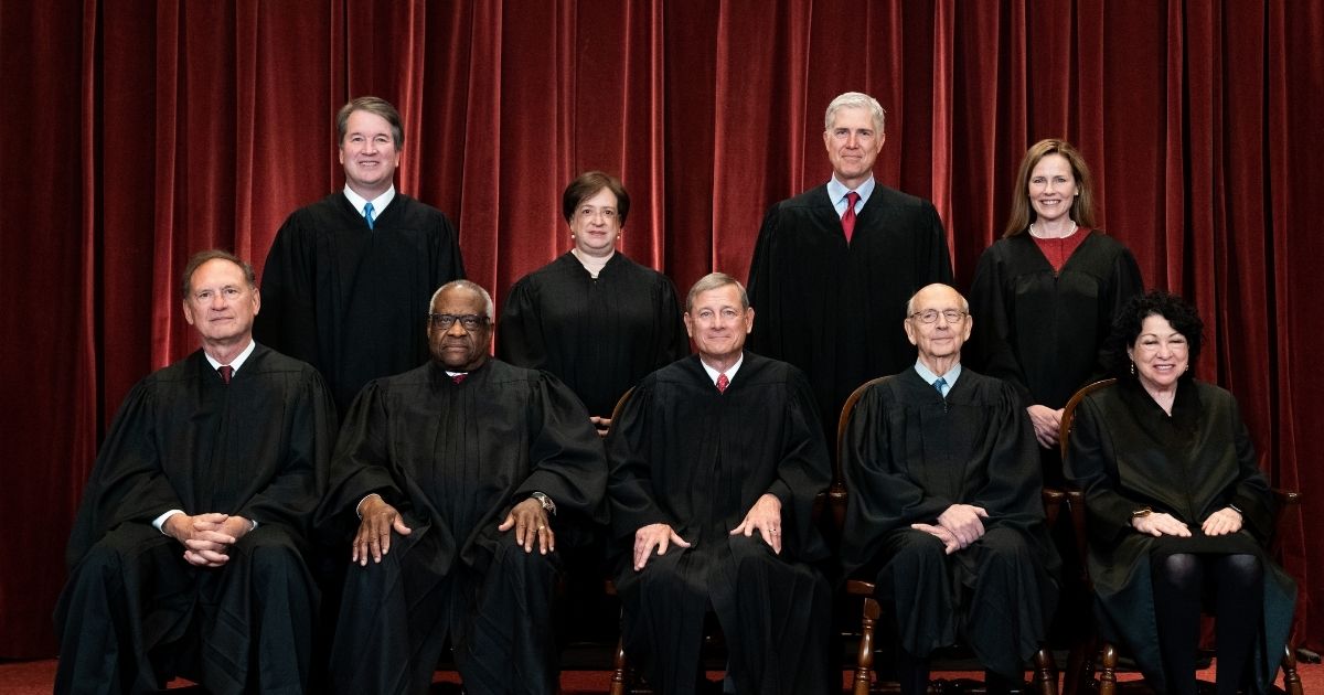 The members of the Supreme Court pose for a group photo in Washington, D.C., on April 23, 2021.