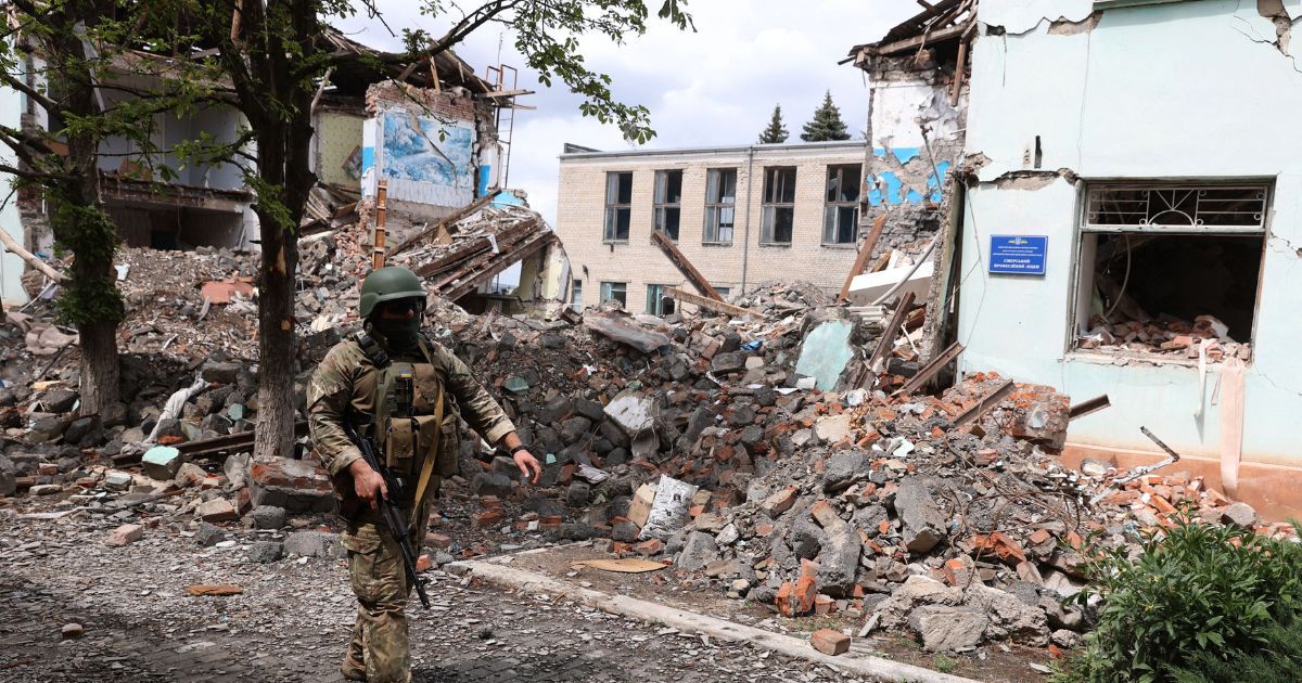 A Ukrainian serviceman walks in front of destroyed buildings in the town of Siversk in Ukraine's Donetsk region on Friday.