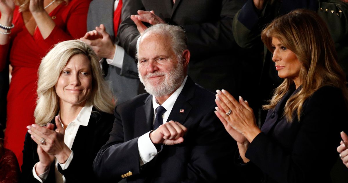 Conservative radio legend Rush Limbaugh is pictured in a February 2020 file photo with his wife, Kathryn, and then-first lady Melania Trump.