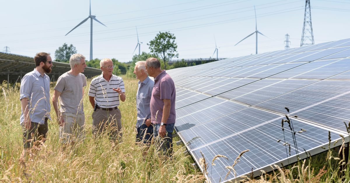 Community members discuss solar panels in this stock photo.