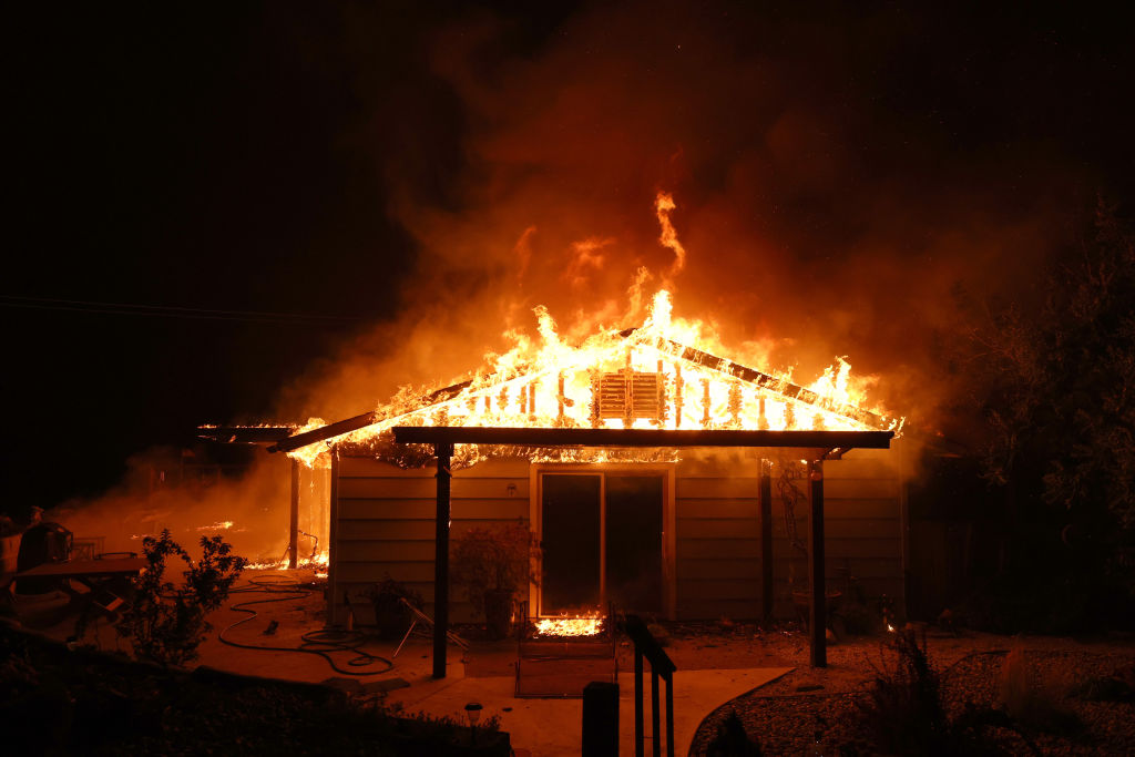 a burning home in California at night