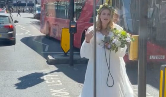 A bride in London makes her way toward the vehicle of a good Samaritan who offered her a ride to the church after three Uber drivers canceled on her at the last minute.