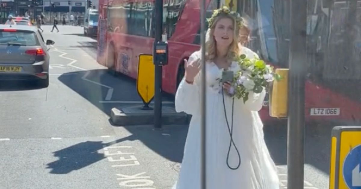 A bride in London makes her way toward the vehicle of a good Samaritan who offered her a ride to the church after three Uber drivers canceled on her at the last minute.