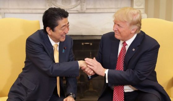 Then-President Donald Trump shakes hands with then-Prime Minister of Japan Shinzo Abe in the Oval Office in February of 2017.