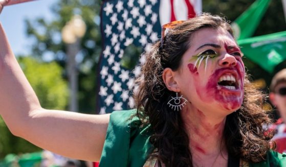 A pro-abortion activist chants in front of the White House on Monday in Washington, D.C.