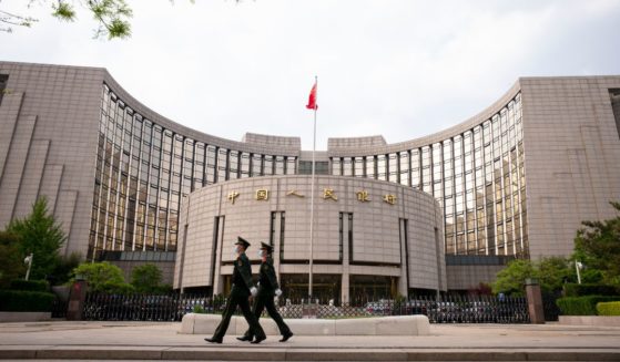 Chinese People's Armed Police walk passed the The People's Bank Of China in the Financial Street on April 17, 2020, in Beijing.