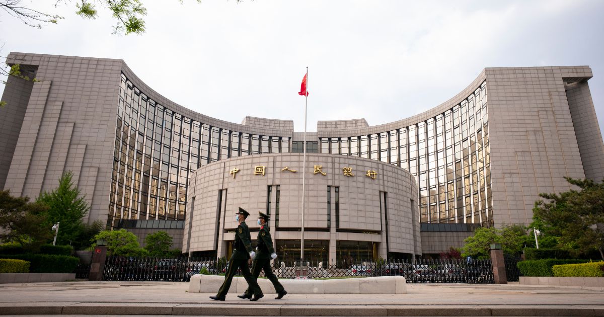 Chinese People's Armed Police walk passed the The People's Bank Of China in the Financial Street on April 17, 2020, in Beijing.