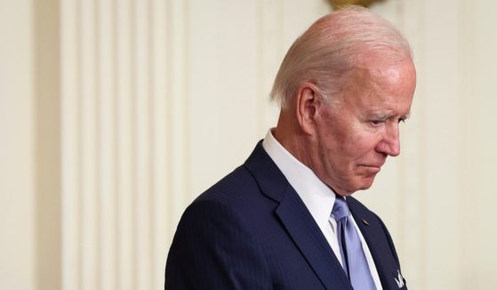 President Joe Biden bows his head in prayer before presenting the Medal of Honor to four U.S. Army soldiers who fought in the Vietnam War during an event in the East Room of the White House on Tuesday in Washington, D.C.