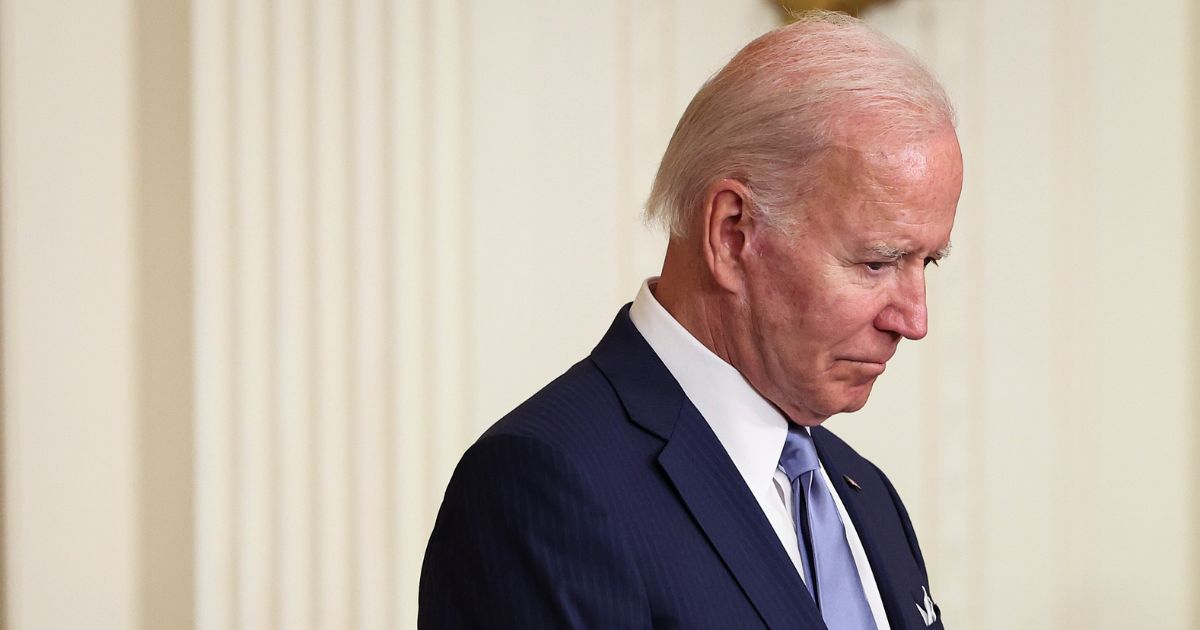 President Joe Biden bows his head in prayer before presenting the Medal of Honor to four U.S. Army soldiers who fought in the Vietnam War during an event in the East Room of the White House on Tuesday in Washington, D.C.