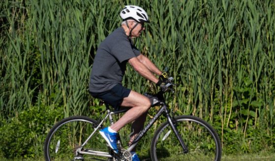President Joe Biden rides his bicycle at Gordon's Pond State Park in Rehoboth Beach, Delaware, on June 18.