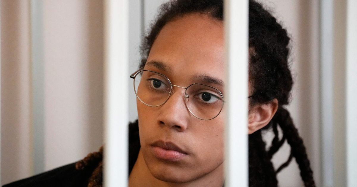 WNBA basketball player Brittney Griner sits inside a defendants' cage before a hearing at the Khimki Court, outside Moscow on Wednesday.
