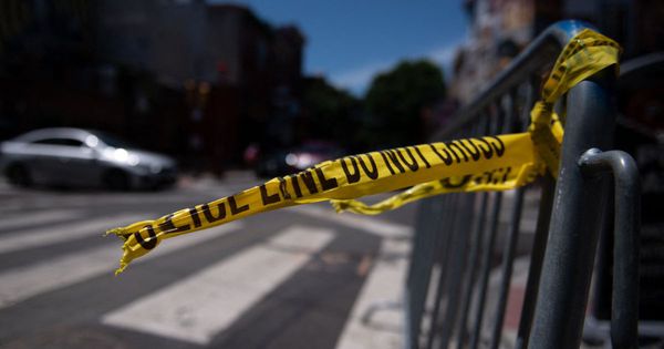 Police tape hangs from a barricade in Philadelphia, Pennsylvania, on June 5, the day after multiple shooters fired into a crowd on a busy street in the city.