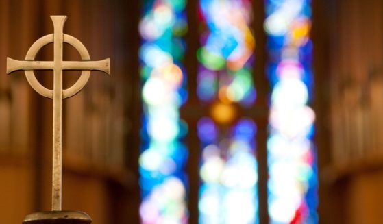 A cross is seen in a church in this stock image.