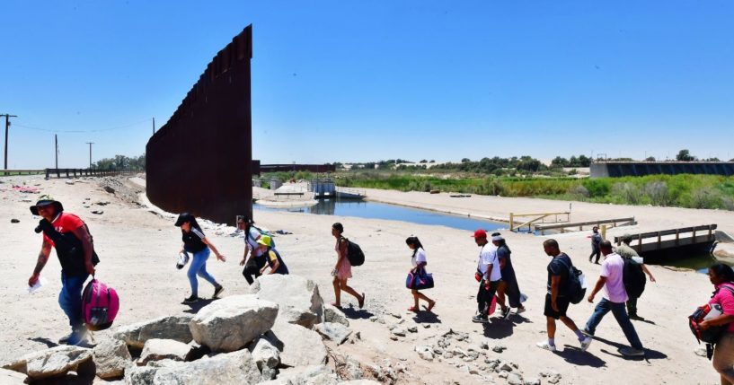 Migrants illegally cross into the U.S. from Mexico through a gap in the border wall separating the Mexican town of Algodones from Yuma, Arizona, on May 16.