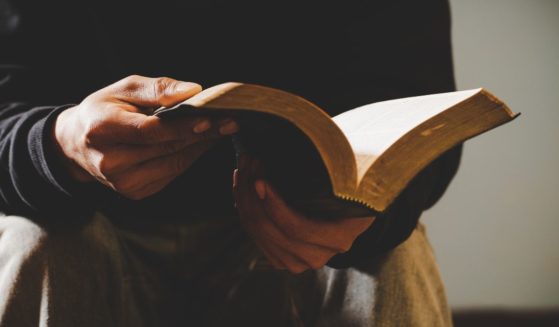 A man reads the Bible in this stock image.