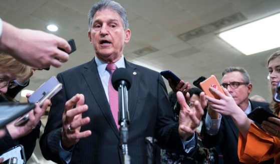 Senator Joe Manchin speaks to the press near the Senate subway following a vote in the Senate impeachment trial that acquitted President Donald Trump of all charges on Feb. 5, 2020, in Washington, D.C.