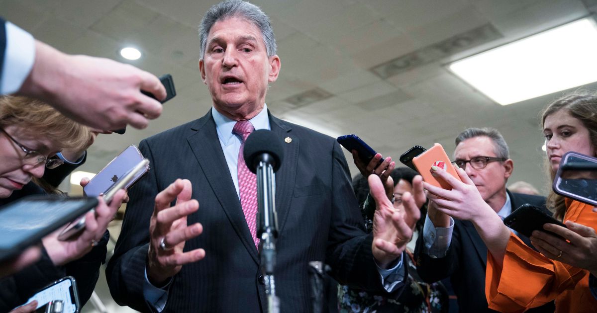 Senator Joe Manchin speaks to the press near the Senate subway following a vote in the Senate impeachment trial that acquitted President Donald Trump of all charges on Feb. 5, 2020, in Washington, D.C.