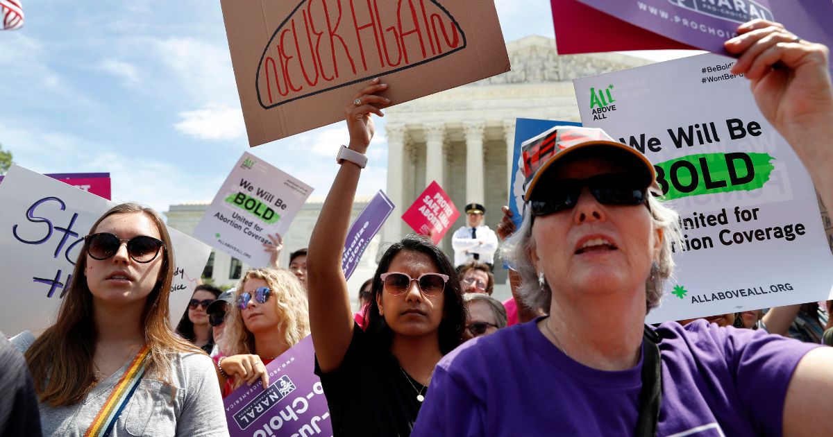 a female student of American University, joins others in a protest against abortion bans outside the Supreme Court
